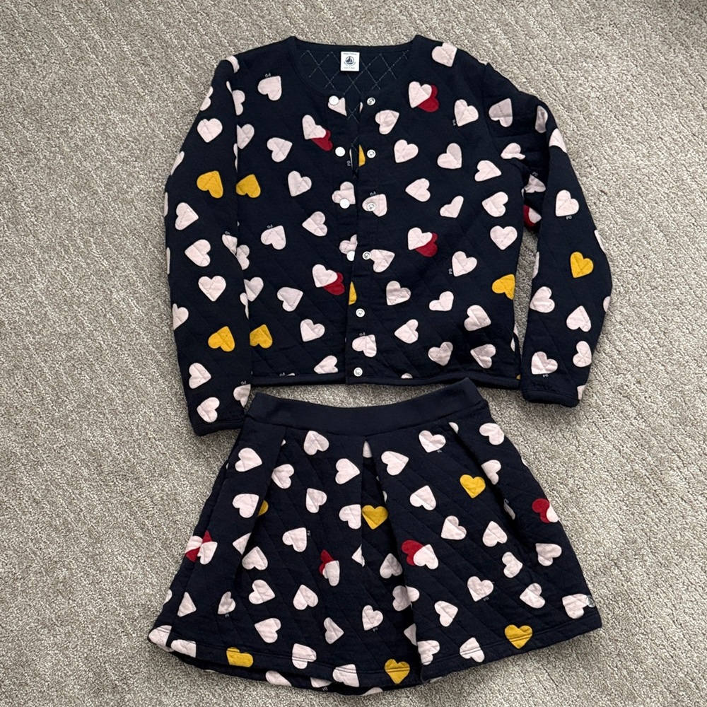 Light quilted jacket and skirt set. Like new. Size 10- navy.